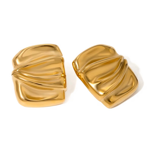 Pair of gold earrings on a white background