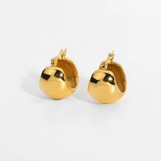 Pair of gold earrings on a white background