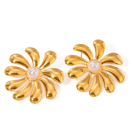 Gold flower-shaped earrings with pearl centers on a white background