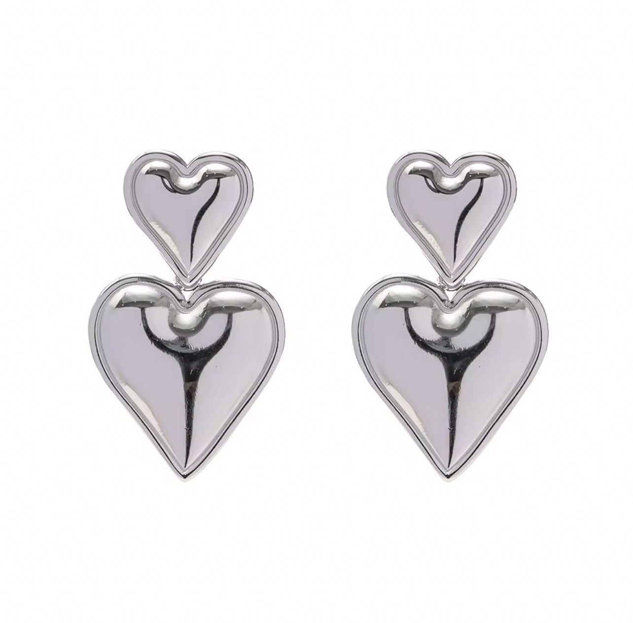 Pair of silver heart-shaped earrings on a white background